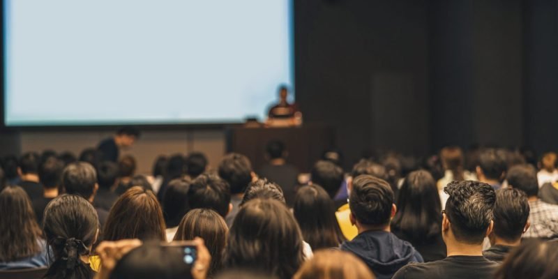 rear-view-of-asian-audience-joining-and-listening-speaker-talking-on-the-stage-in-the-seminar-e1700247620612.jpg